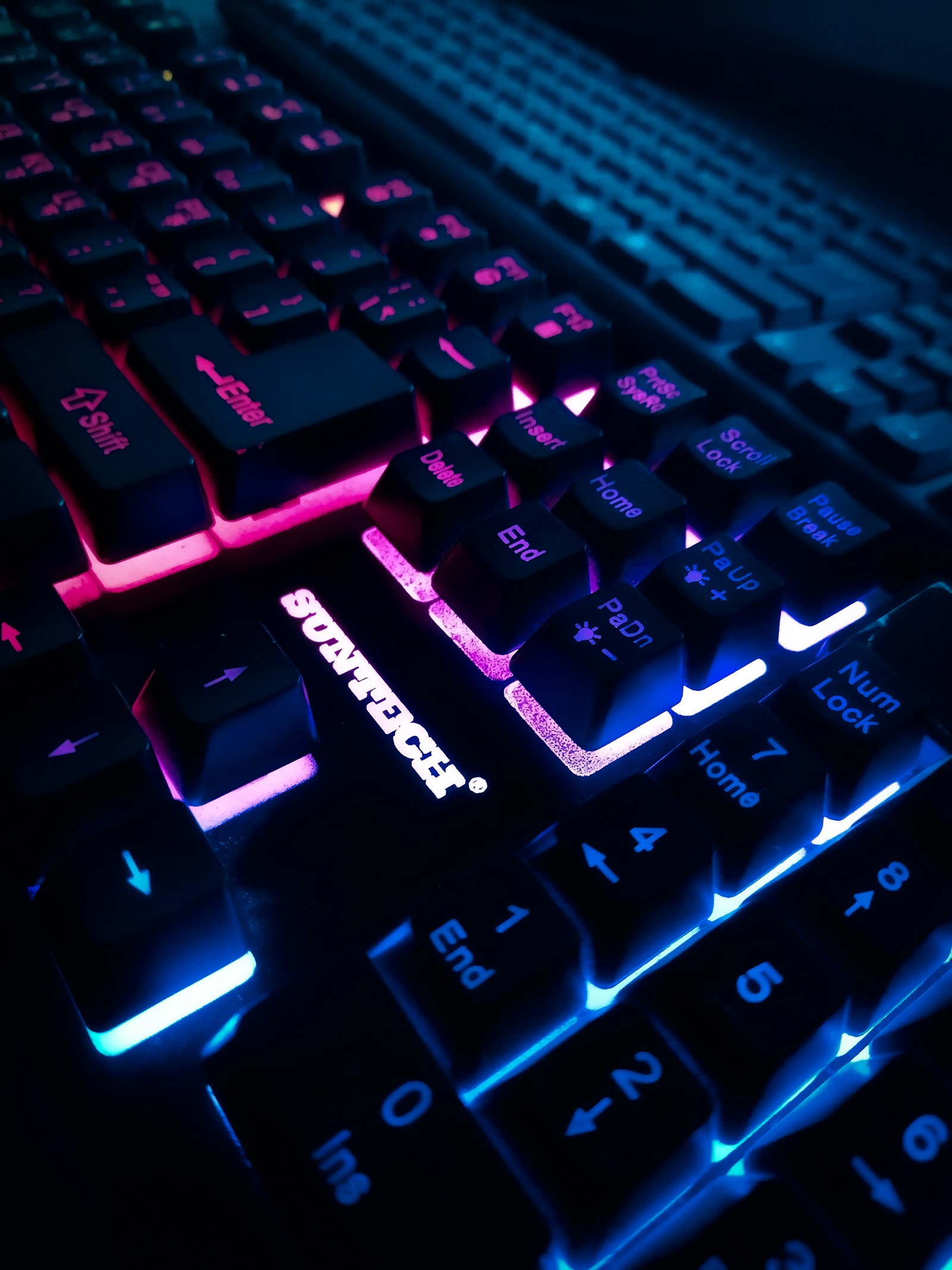 Backlit mechanical gaming keyboard in a dark room